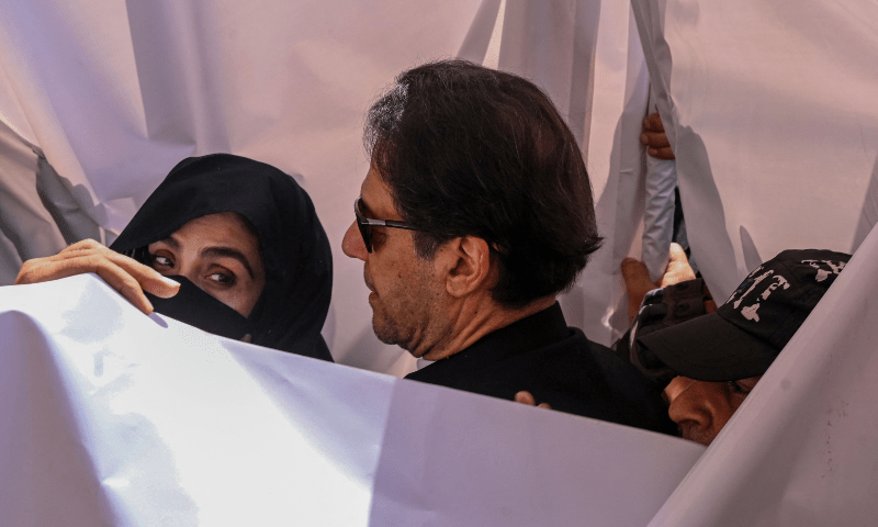 The file photo shows former premier Imran Khan and his wife Bushra Bibi outside a court last year. — AFP