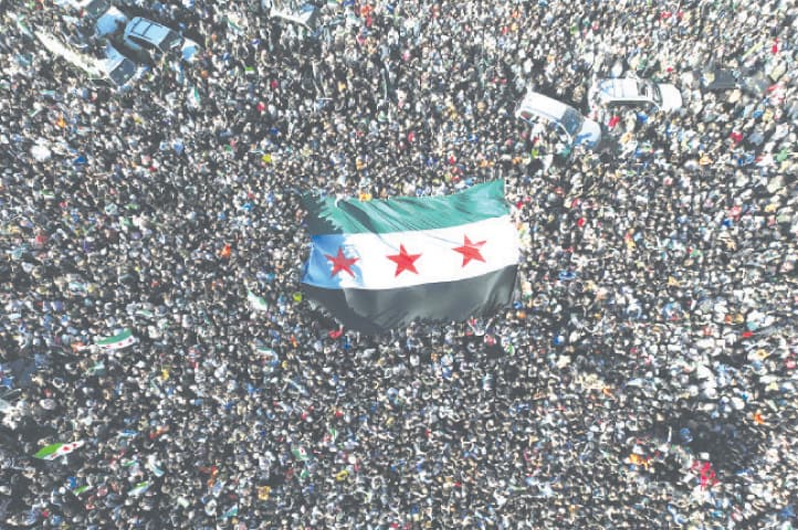  PEOPLE celebrate the fall of Bashar al-Assad’s government in Damascus’s Umayyad Square. — Dawn archive 