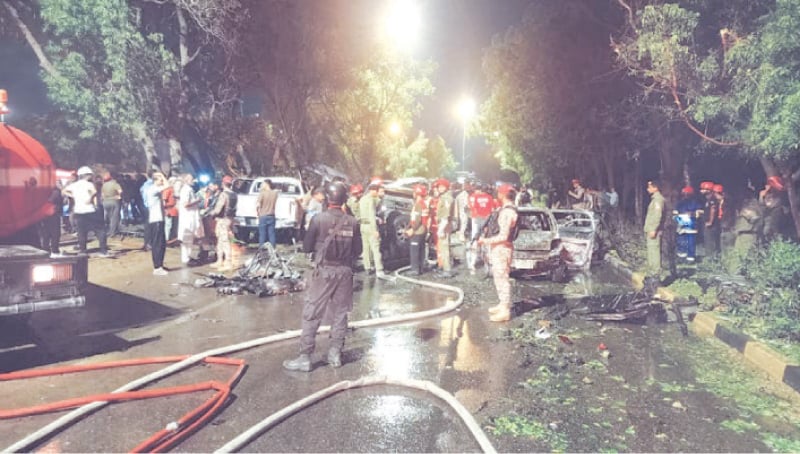  First responders and security officials at the site of the blast targeting Chinese engineers outside Karachi airport in October. — White Star/File 