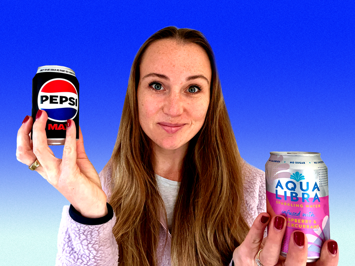 Rachel Hosie holding a can of Pepsi Max in one hand and a can of Aqua Libra in the other.