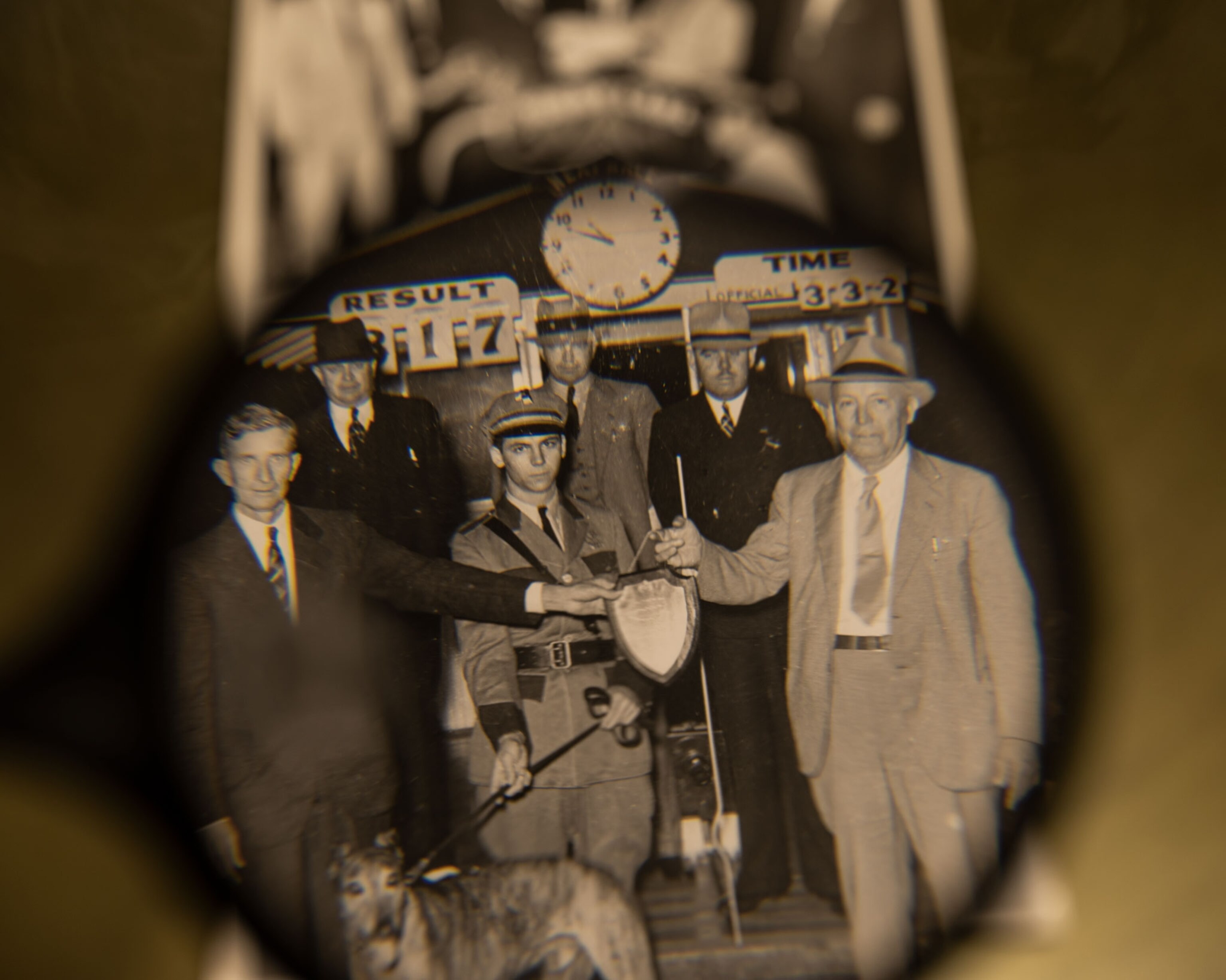 a magnifying glass over an old black and white photograph of a greyhound