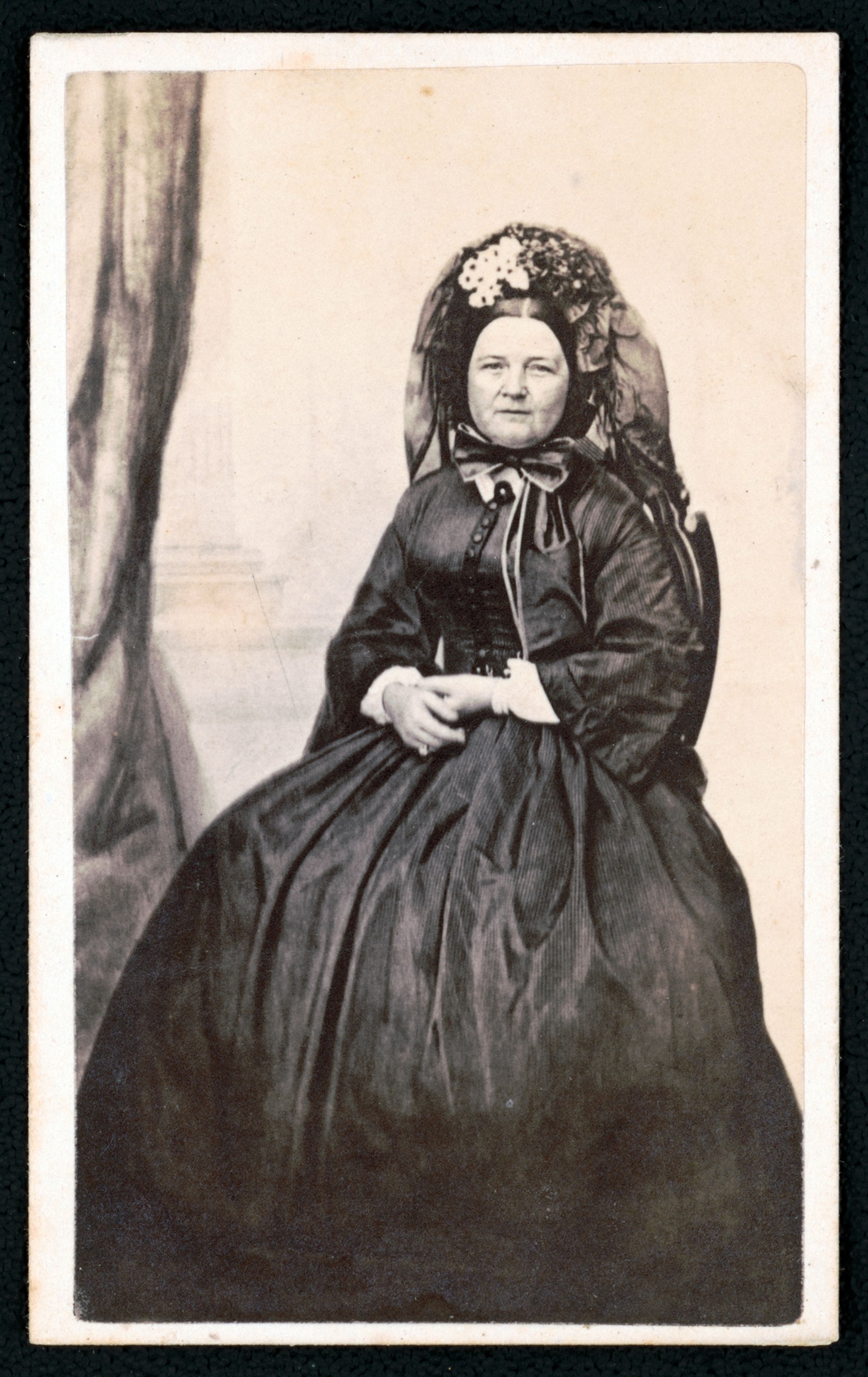 An old, sepia toned, portrait, photograph of Mary Lincoln in mourning attire