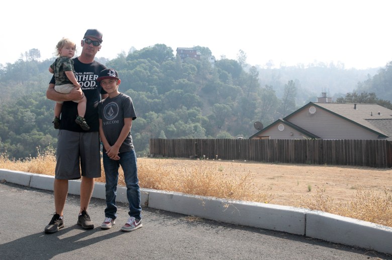 Kody Petrini with his sons, Levi, 16 months, and Steven, 11, in Berryessa Highlands on Sept. 21, 2020. Petrini lost his home in the LNU Lighting Complex Fires and for more than a month afterward was afraid to bathe Levi with tap water for fear of contaminants. Photo by Anne Wernikoff for CalMatters