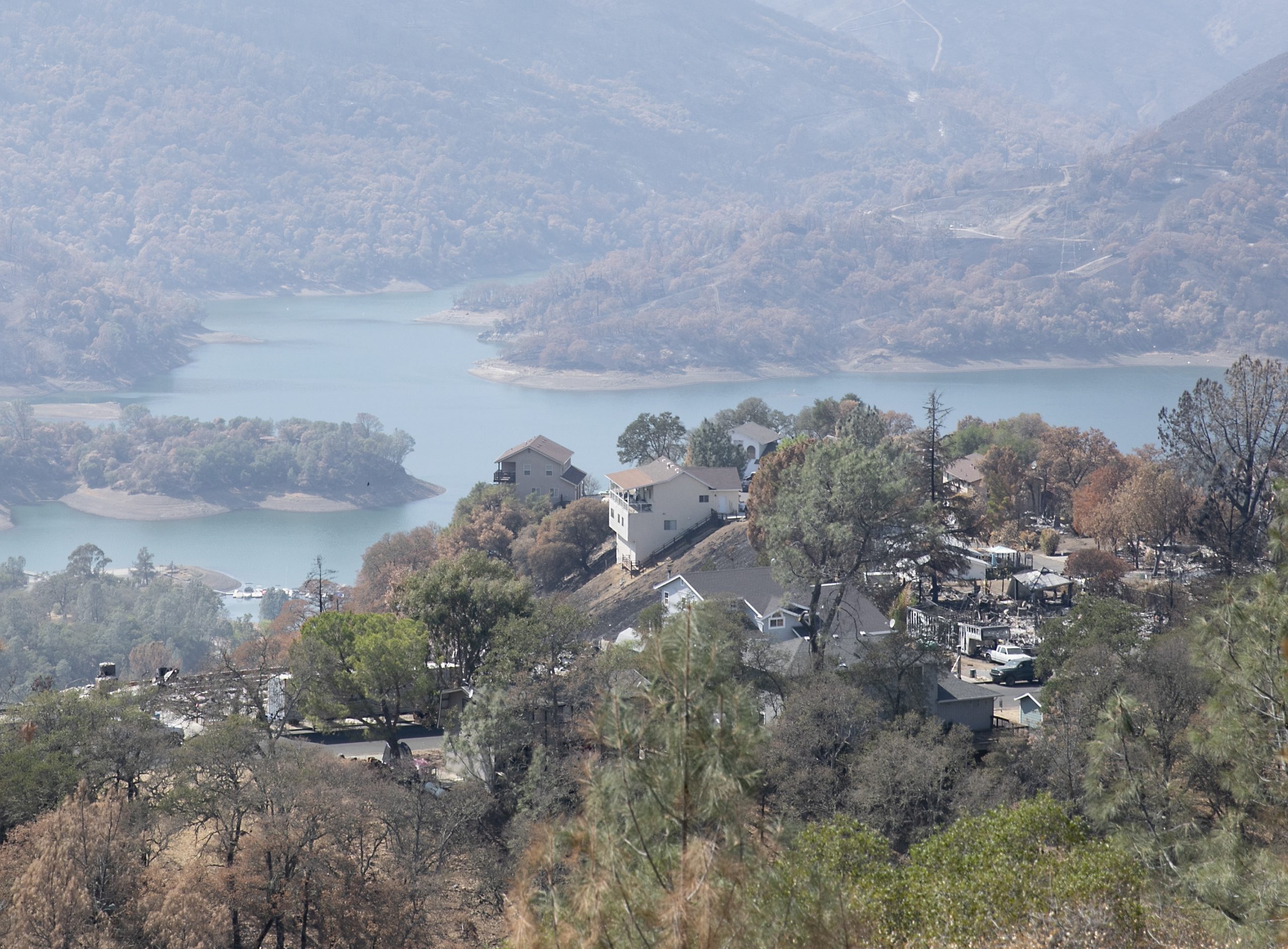 Homes destroyed by the LNU Lighting Complex Fire seen interspersed with untouched homes above Lake Berryessa, a resort area and water supply reservoir, on Sept. 21, 2020. Following the lighting complex fires in August, residents were advised not to drink or boil the tap water out of concerns for benzene and other contaminants. Photo by Anne Wernikoff for CalMatters