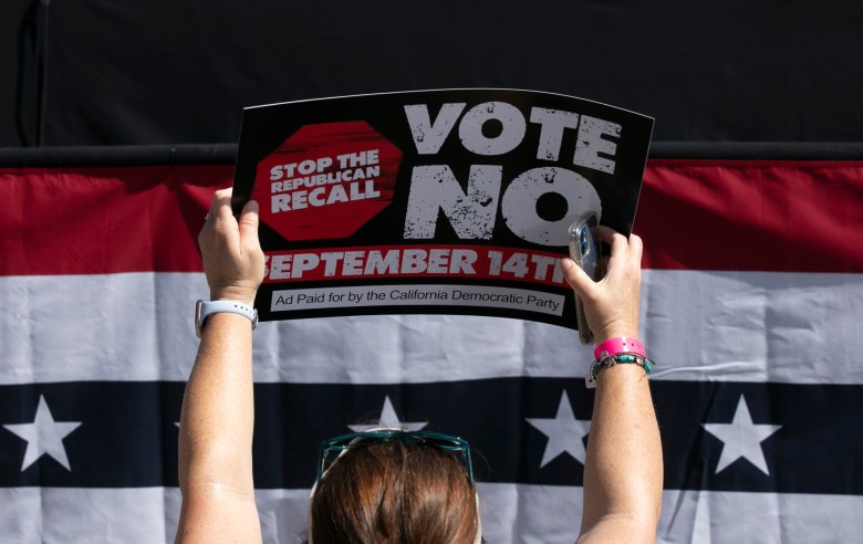 A Gavin Newsom supporter holds up a sign against the recall at a campaign event at the IBEW-NECA training center in San Leandro on Sept. 8, 2021. Photo by Anne Wernikoff, CalMatters