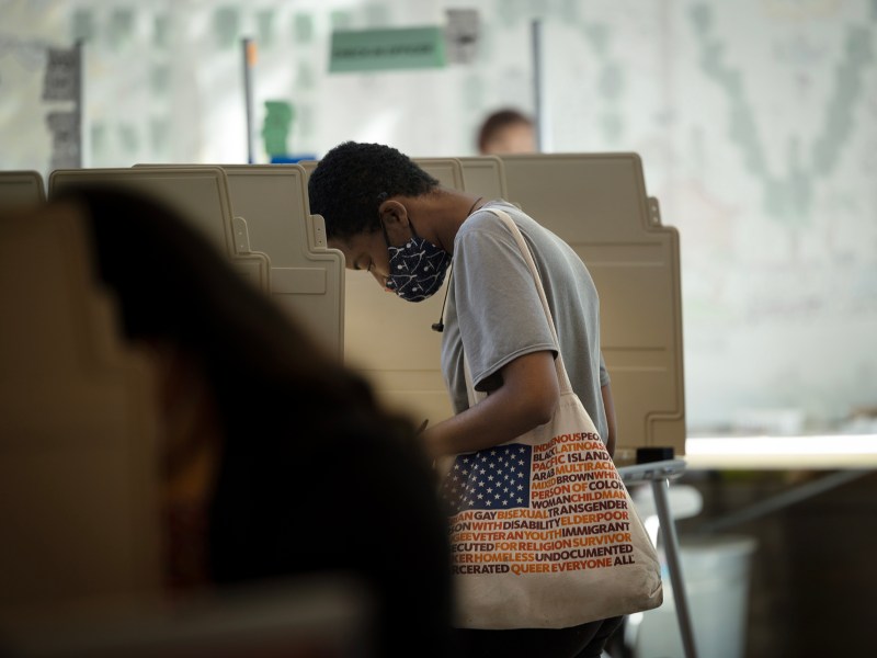 Voters cast their ballot at a voting site at the California Museum in downtown Sacramento on June 7, 2022. Photo by Miguel Gutierrez Jr., CalMatters