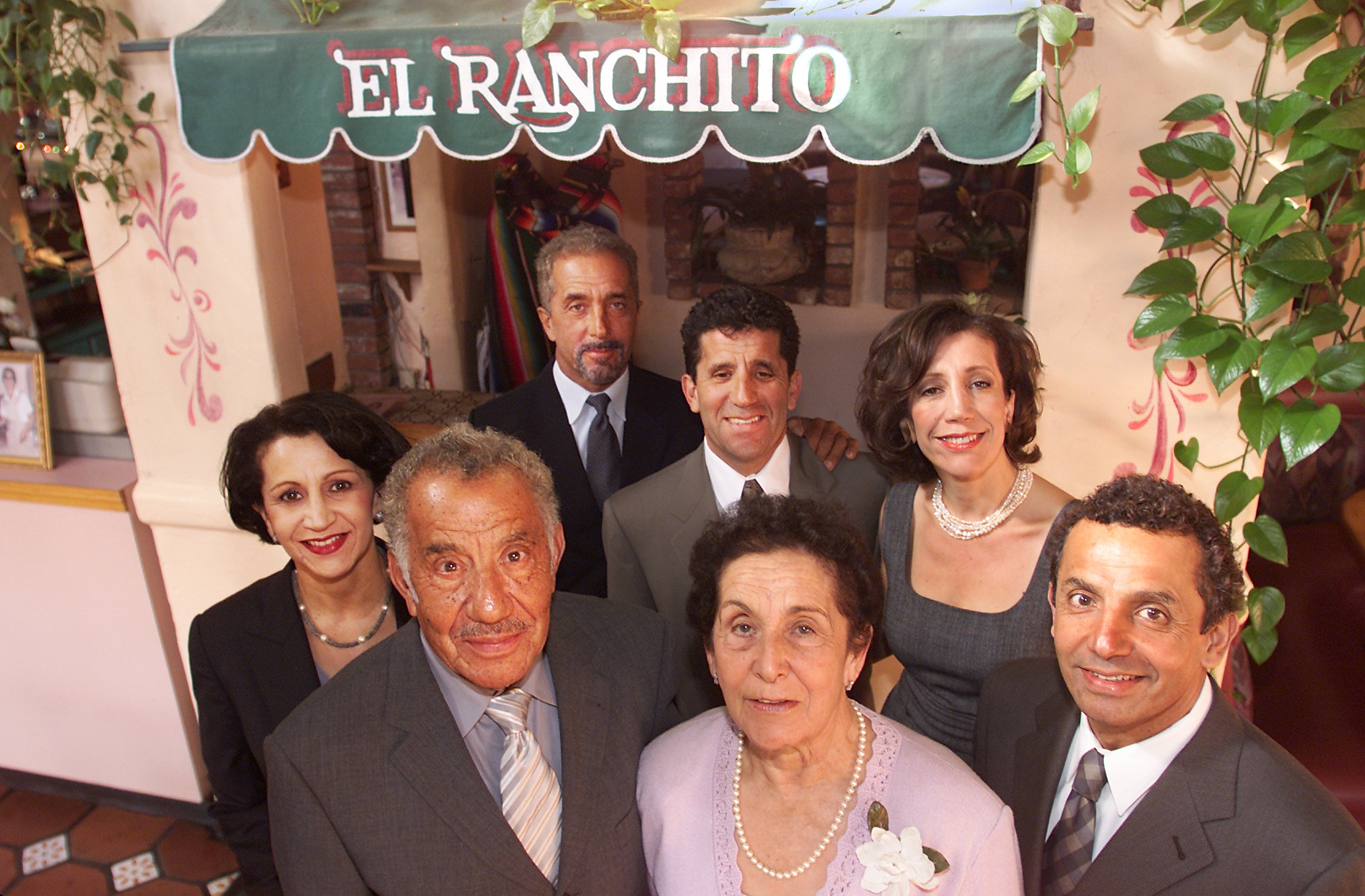 The Avila family, (clockwise from lower left) patriarch Salvador, his daughter Maria Elena, Salvador Jr., Victor, Margie, Sergio and wife Margarita at El Ranchito restaurant in Costa Mesa in 2001. Salvador Avila died at age 99. (Photo by Eugene Garcia, Orange County Register/SCNG)