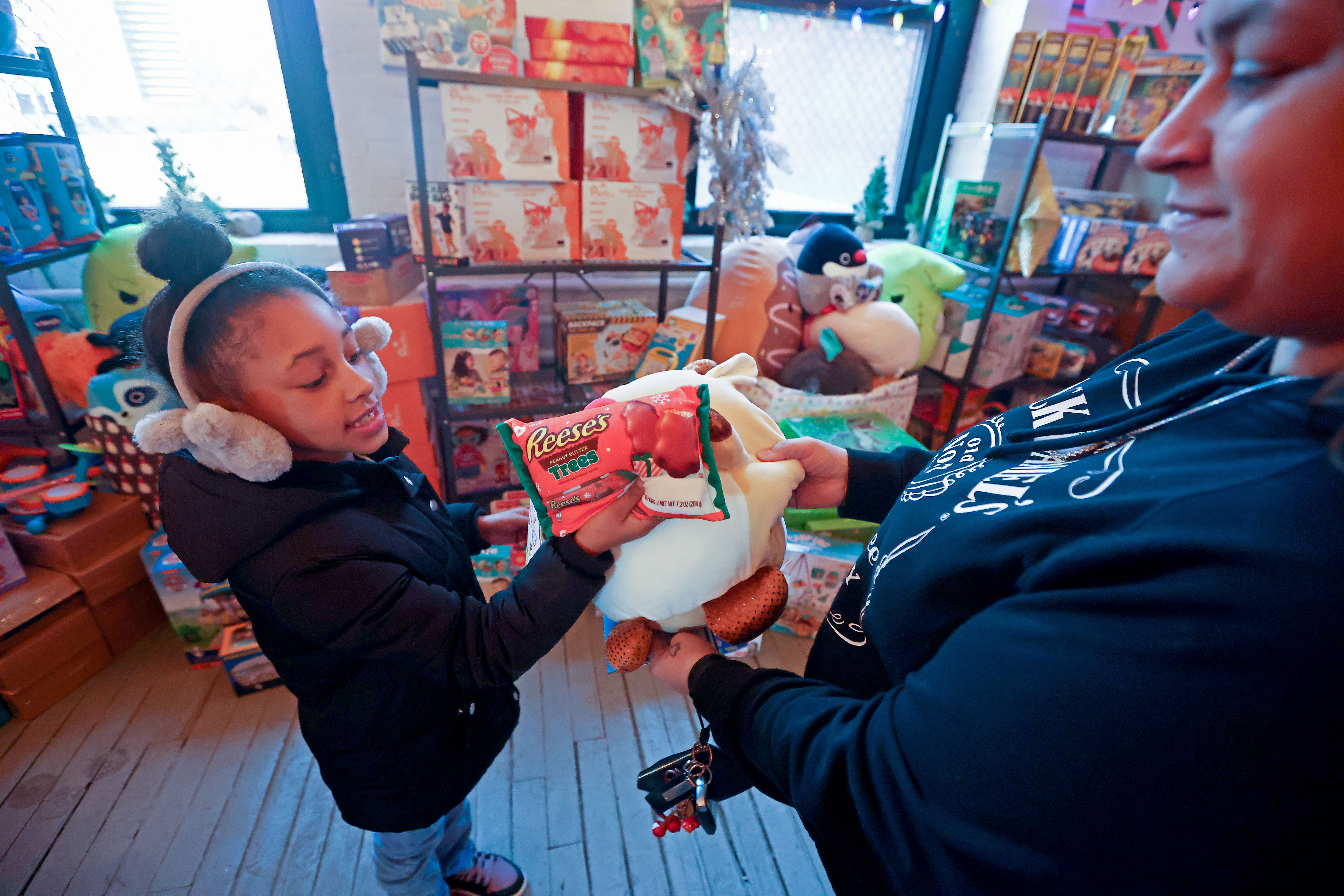 Carmen, 6, picks out a plush gift, not for herself, but her cousin whose mom just lost her job as Boston Community Pediatrics and other agencies give away more than 1000 gifts to families in need for Christmas on Dec. 13. (Staff Photo By Stuart Cahill/Boston Herald)