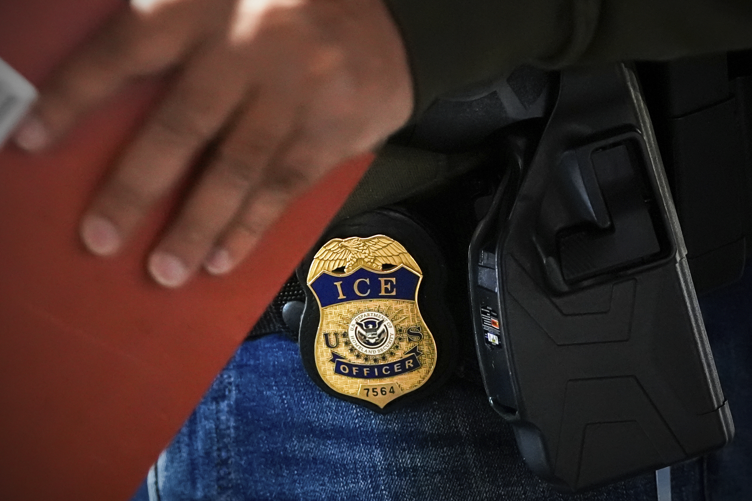 A deportation officer with Enforcement and Removal Operations in U.S. Immigration and Customs Enforcement's New York City field office conducts a brief before an early morning operation last month in New York. (AP Photo/Julia Demaree Nikhinson)