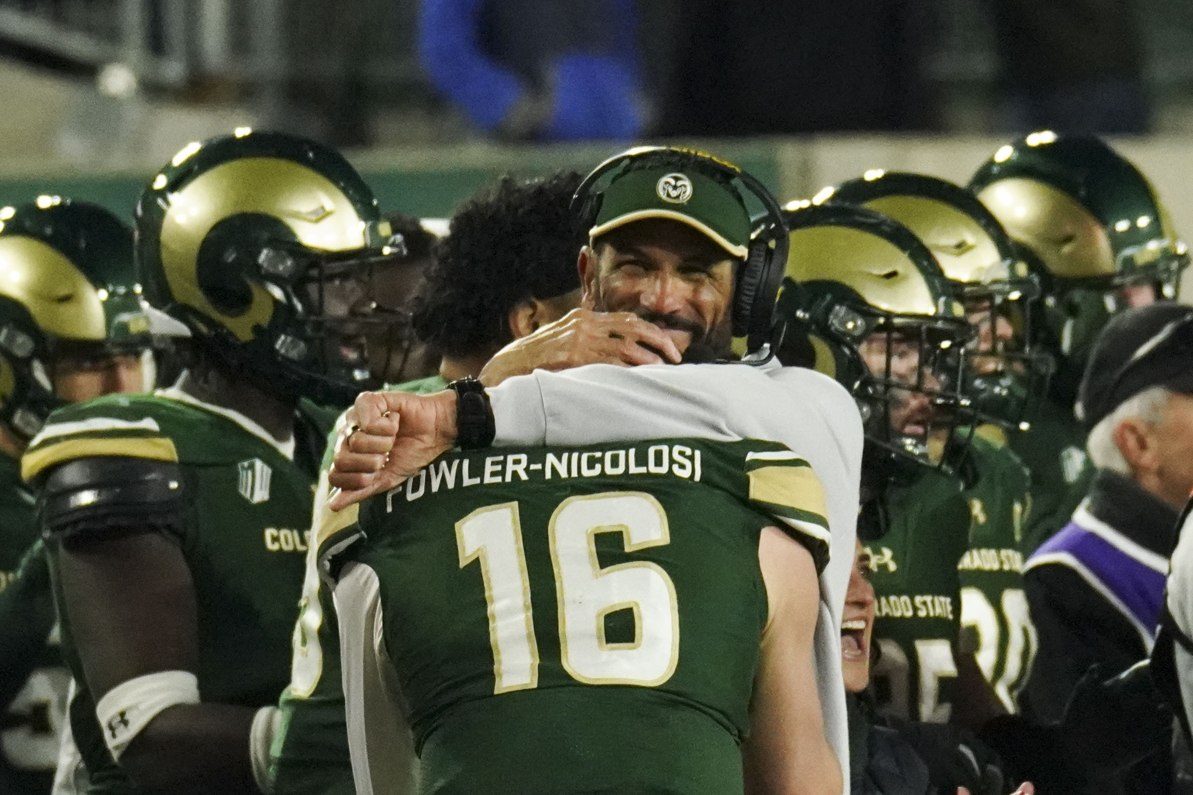 Colorado State University's head coach Jay Norvall hugs Brayden Fowler-Nicolosi (16) after winning against Utah State University at Canvas Stadium, Friday, Nov. 29, 2024 in Fort Collins. Colorado State University won the game 42-37 against Utah State University. (Rebecca Slezak/Special to The Denver Post)