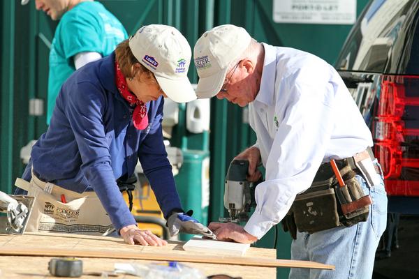 Former President Jimmy Carter and first lady Rosalynn Carter work together to make a precise cut as they work on installing a windowsill at the Brookfield Court development in Oakland, Calif., on Monday, Oct. 7, 2013. The Carters visited the 12-home development being built by Habitat for Humanity in Oakland's Brookfield Village neighborhood.(Laura A. Oda/Bay Area News Group)