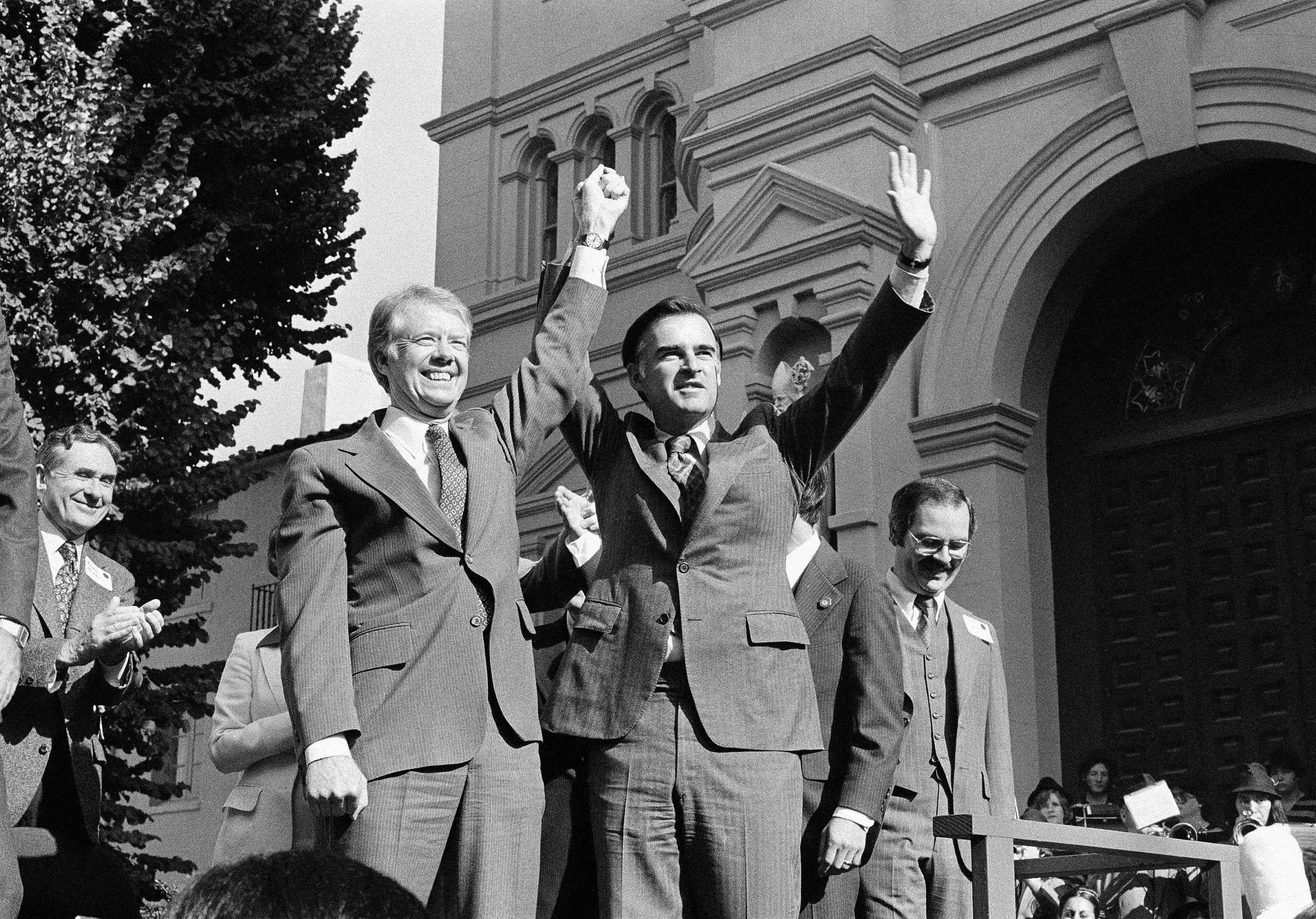 FILE - In this Nov. 3, 1978 file photo, President Jimmy Carter, left, and California Governor Edmund G."Jerry" Brown Jr. wave to the crowd during visit to Sacramento, Calif. On Monday, Oct. 7, 2013, Brown will become the state's longest serving governor, surpassing Earl Warren's 10-year tenure in the office. Warren served as governor from Jan. 4, 1943 to Oct. 5, 1953, when he resigned to join the U.S. Supreme Court. Brown held the office from 1975-1983 and was able to run for governor again because his first stint as governor came before California's term limits laws, which restricts governors to two terms in office. (AP Photo/file)