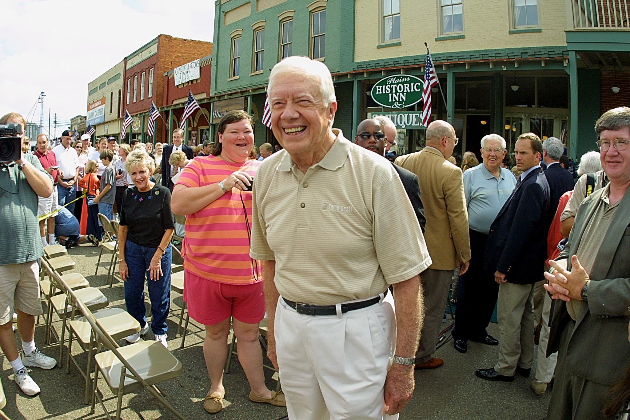 Former U.S. president Jimmy Carter wanders through the crowd shaking hands and receiving hugs after a press conference where he talked about receiving the Noble Peace Prize 11 October, 2002 in Plains, Georgia. A commitment to human rights and the alleviation of human suffering was not only a guiding principle of his single, four-year term as 39th president of the United States, but the cornerstone of The Carter Center he founded 20 years ago to pursue his vision of world diplomacy.AFP PHOTO Steve SCHAEFER (Photo credit should read STEVE SCHAEFER/AFP/Getty Images)