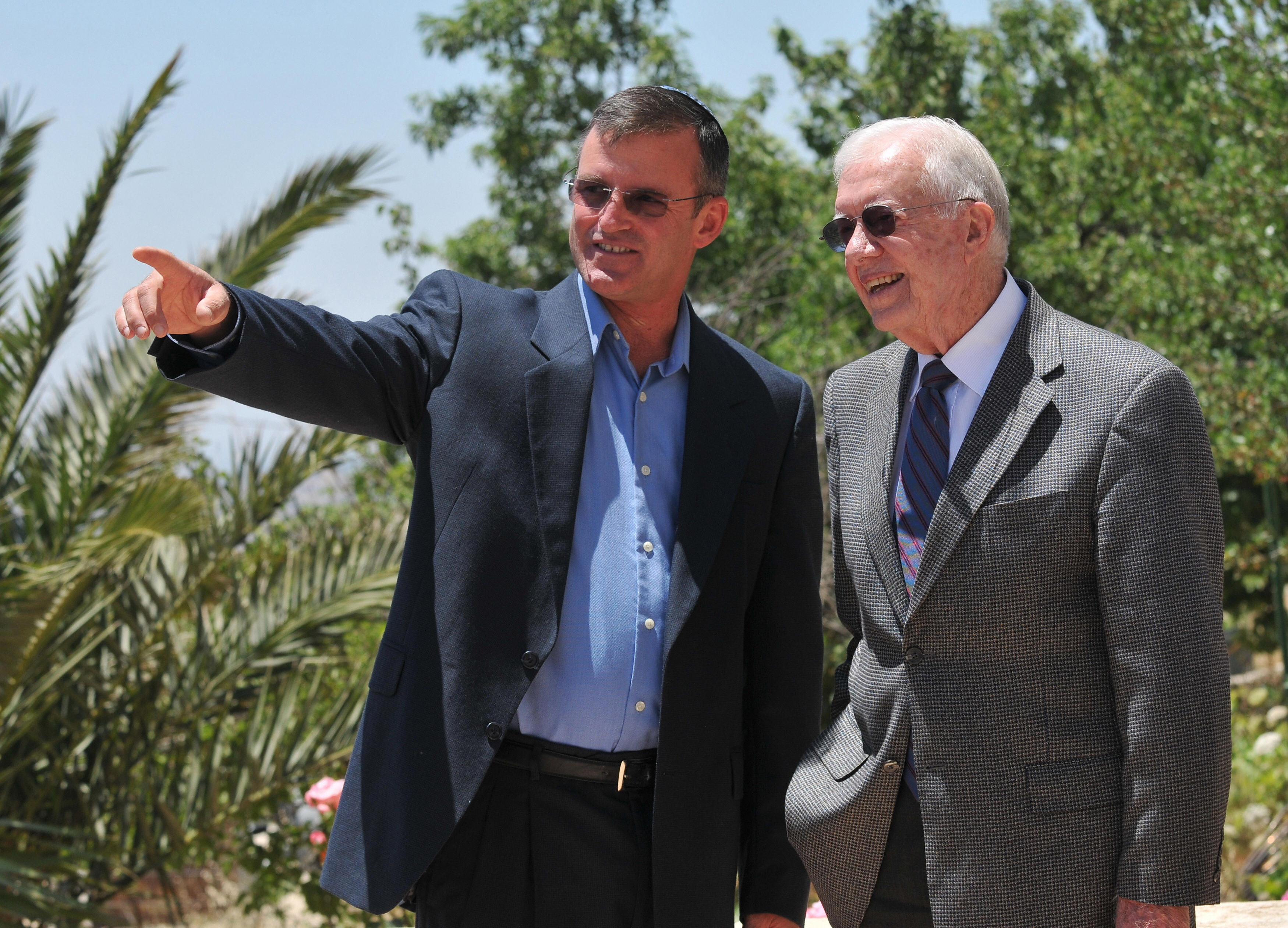 Former US president Jimmy Carter (R) listens to Shaul Goldshtein, head of the Gush Etzion municipality, as he visits the Jewish settlement of Neve Daniel in the occupied West Bank on June 14, 2009. Israel is headed for a clash with main ally the United States over the issue of Jewish settlements, former US president Jimmy Carter said in an interview with the liberal Haaretz newspaper. (Yehuda Raizner/AFP/Getty Images)