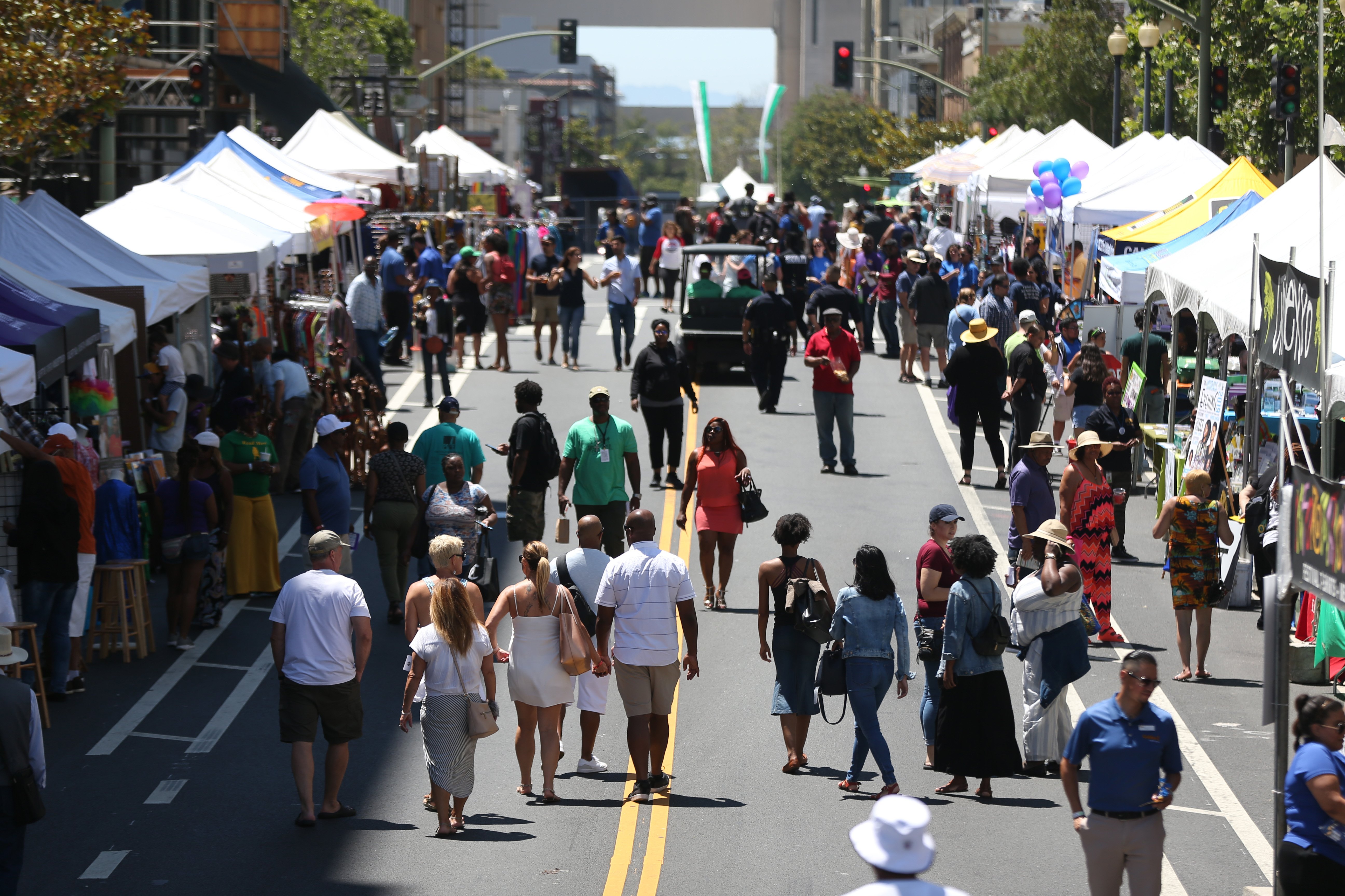 OAKLAND, CALIFORNIA - JULY 27: Festival goers mix and mingle during the Art + Soul Oakland event in Oakland, Calif., on Saturday, July 27, 2019. The event featured music, dance, an artisan marketplace, craft beer, wine, food, a fun zone and performers on different stages. The event ends Sunday. (Ray Chavez/Bay Area News Group)