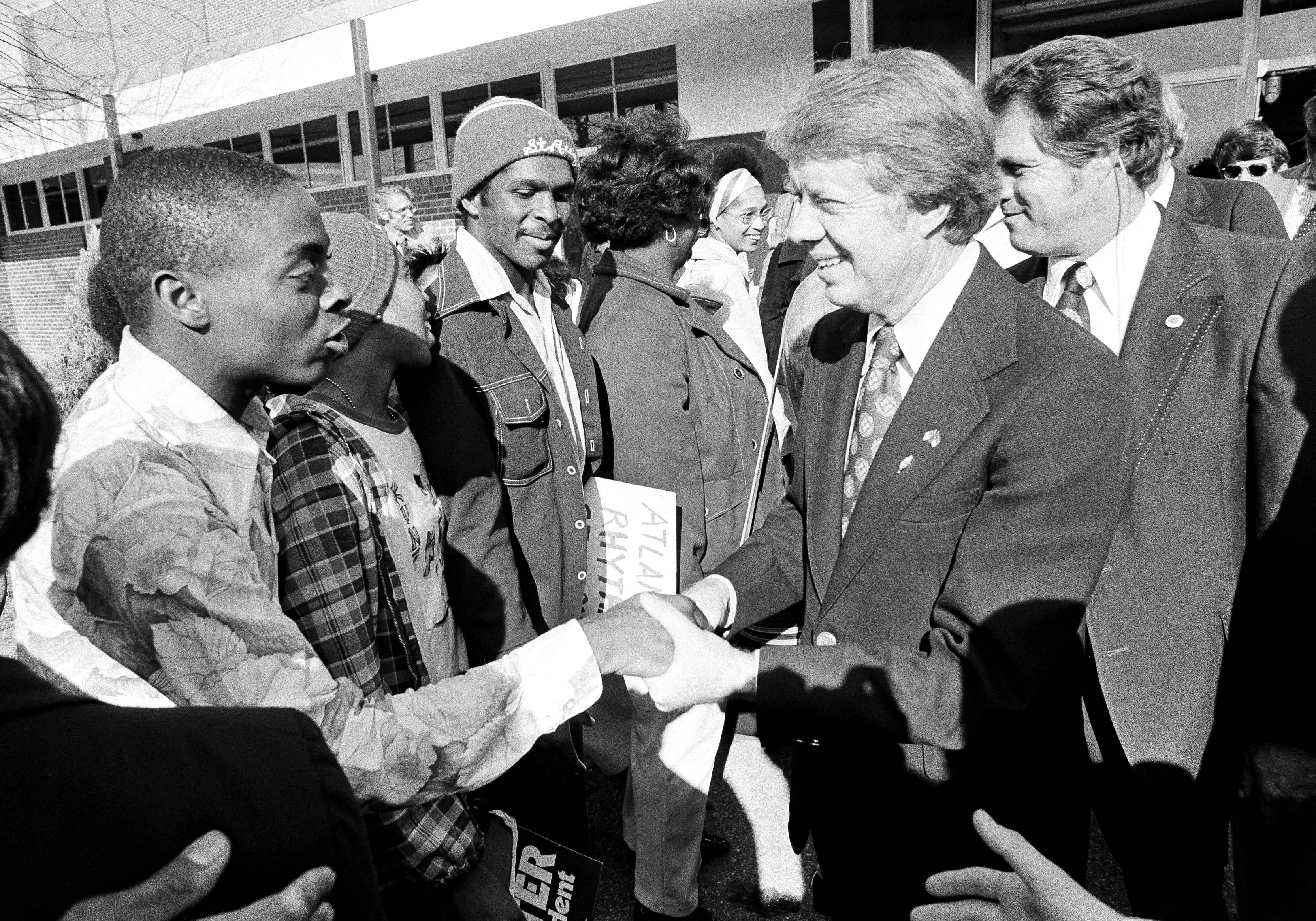 FILE - Democratic presidential candidate Jimmy Carter is escorted by Massachusetts Sen. Edward M. Kennedy, Sept. 30, 1976, as Carter landed at Boston's Logan Airport for a campaign stop on his New England tour. Carter announced his campaign for the presidency in December 1974. At that point he had never met an American president. He later said part of what nudged him into the race was meeting several candidates ahead of the 1972 campaign and concluding that he was talented as they were. (AP Photo/Jeff Taylor, File)