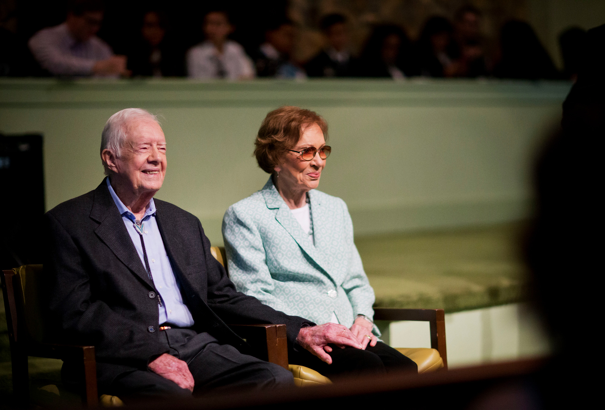 Former President Jimmy Carter, left, sits with his wife Rosalynn as they wait to pose for photos after Carter taught Sunday School class at Maranatha Baptist Church in his hometown, Sunday, Aug. 23, 2015, in Plains, Ga. More than 700 people heard Carter deliver a familiar message this weekend: When your burden grows heavy, ask God for strength. (AP Photo/David Goldman)