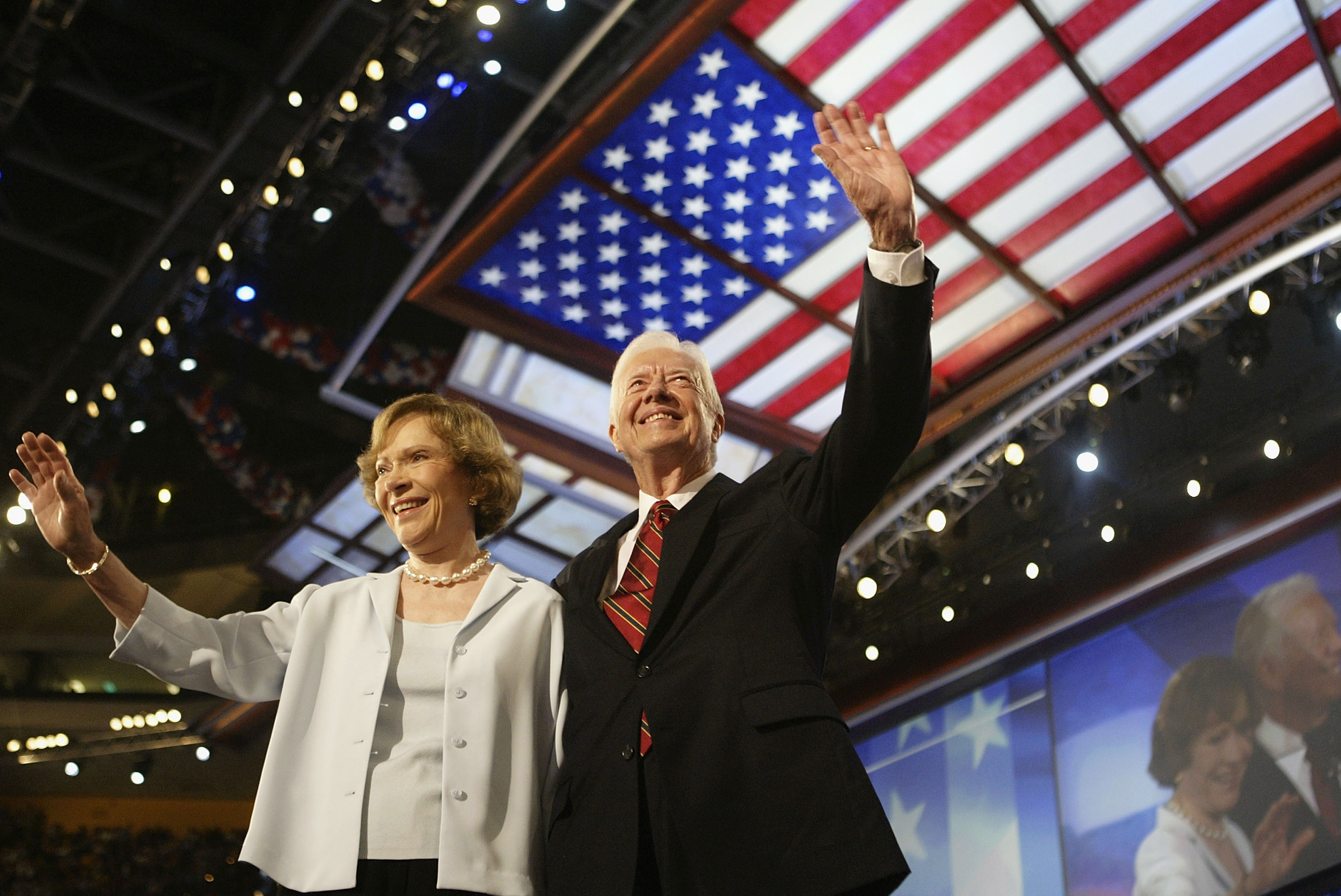 Former U.S. President Jimmy Carter and his wife Rosalynn wave to the audience during the Democratic National Convention at the FleetCenter July 26, 2004 in Boston, Massachusetts. Democratic presidential candidate U.S. Senator John Kerry (D-MA) is expected to accept his party's nomination later in the week. (Photo by Scott Olson/Getty Images)