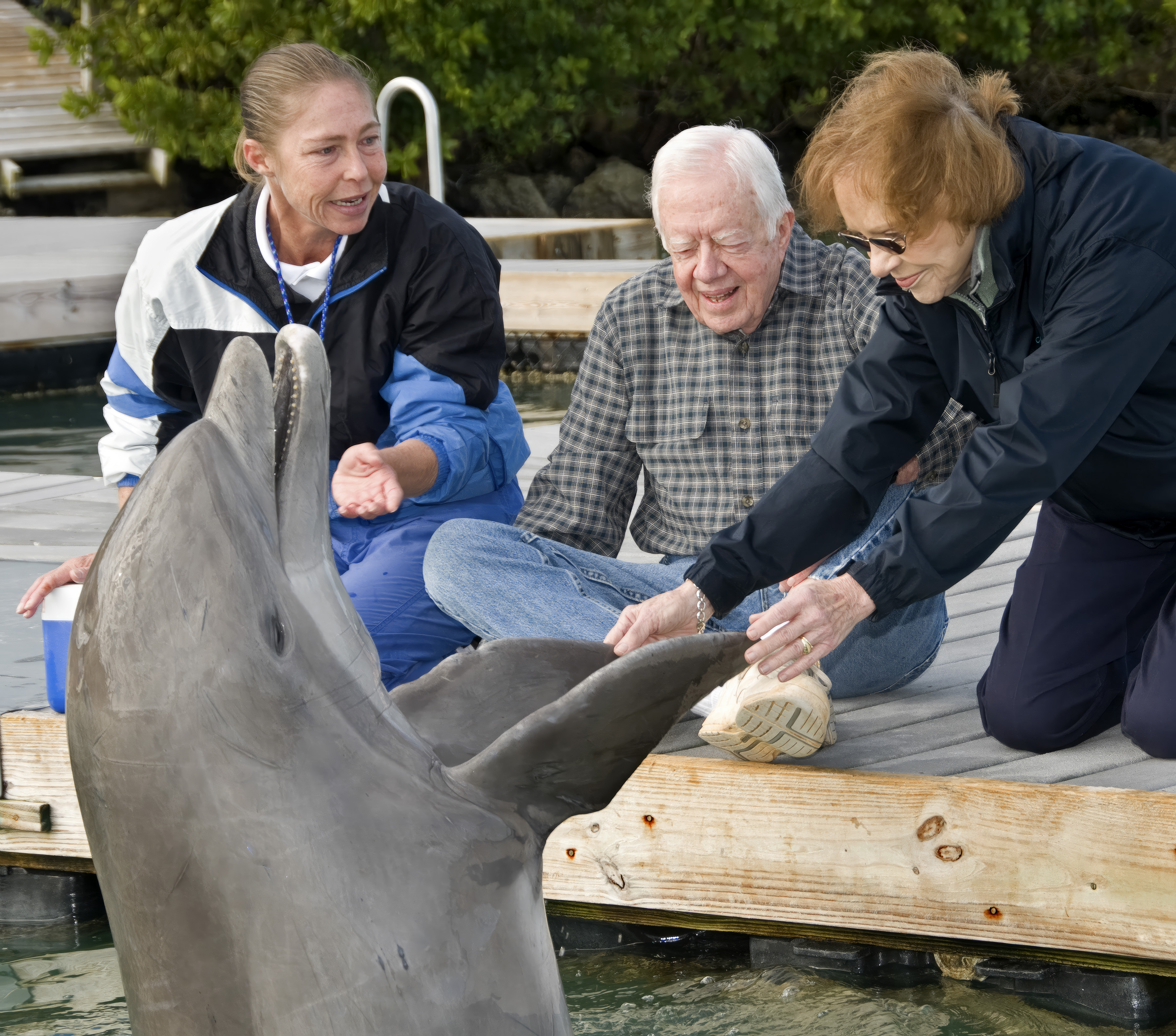 In this photo provided by the Florida Keys News Bureau, Rosalynn Carter, right, wife of former President Jimmy Carter, center, greets Nemo the dolphin at Hawk's Cay Resort near Marathon, Fla., Dec. 29, 2010, in the Florida Keys. On Sunday, Nov. 19, 2023, The Carter Center announced that the 96-year-old former first lady had died at her rural Plains, Georgia, home. Back in 2010, the couple and their family stayed at the resort during a vacation in the Florida Keys. (Andy Newman/Florida Keys News Bureau via AP)