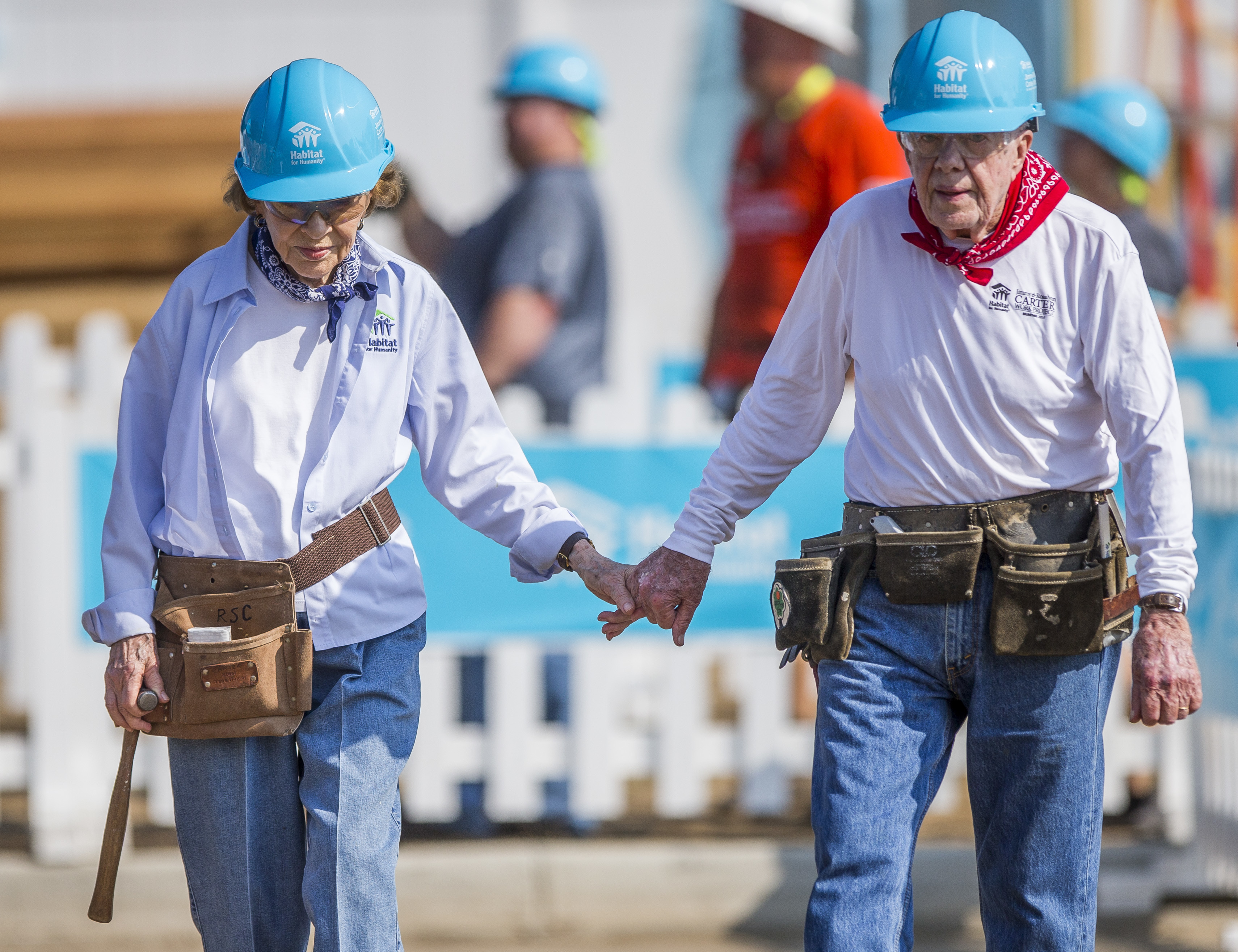 FILE - Former President Jimmy Carter, right, holds hands with his wife, former first lady Rosalynn Carter, as they work with other volunteers on site, Aug. 27, 2018, in Mishawaka, Ind. Rosalynn Carter, the closest adviser to Jimmy Carter during his one term as U.S. president and their four decades thereafter as global humanitarians, died Sunday, Nov. 19, 2023. She was 96. (Robert Franklin/South Bend Tribune via AP, File)