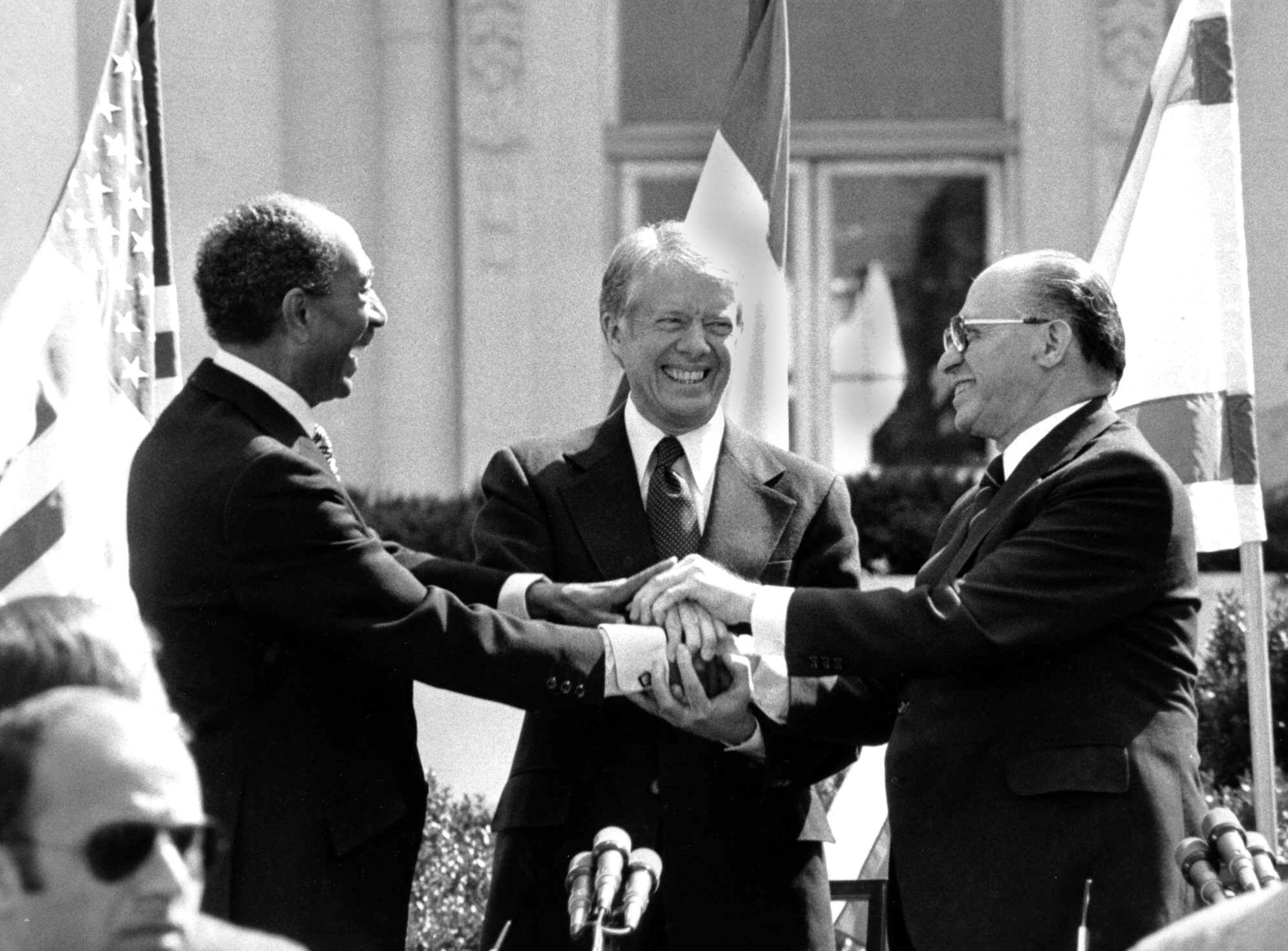 FILE--Egyptian President Anwar Sadat, left, U.S. President Jimmy Carter, center, and Israeli Prime Minister Menachem Begin clasp hands on the north lawn of the White House after signing the peace treaty between Egypt and Israel on March 26, 1979. Sadat and Begin were awarded the Nobel Peace Prize for accomplishing peace negotiations in 1978. The rest of the Arab world shunned Sadat, condemning his initiative for peace. President Carter was pivotol for the two leaders to meet at Camp David and as a result, peace began between Arabs and Jews. It was shattered when Sadat was assassinated in Cairo on Oct. 6, 1981. (AP Photo/Bob Daugherty)