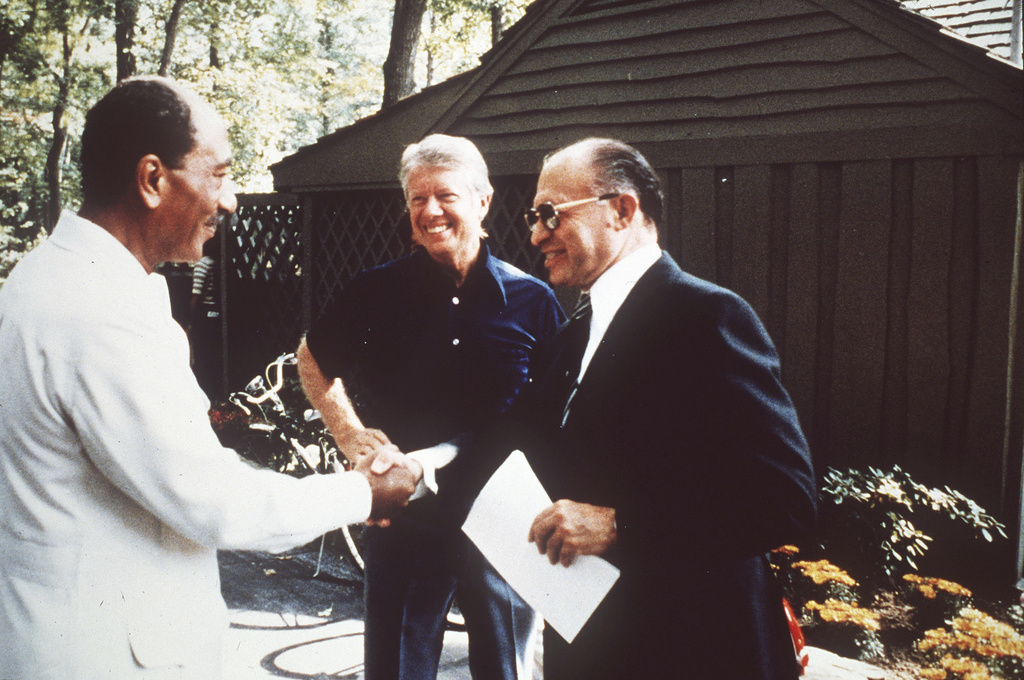 FILE - Egypt's President Anwar Sadat, left, shakes hands with Israeli Prime Minister Menachem Begin as President Jimmy Carter watches at Camp David, Md., in September 1978, during talks aimed at laying the groundwork for a permanent Middle East peace. (AP Photo, File)