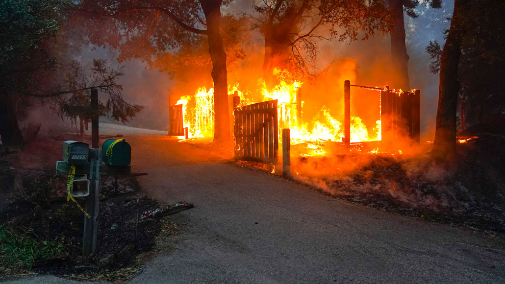 a home burning in the 2020 CZU Lightning Complex Fire