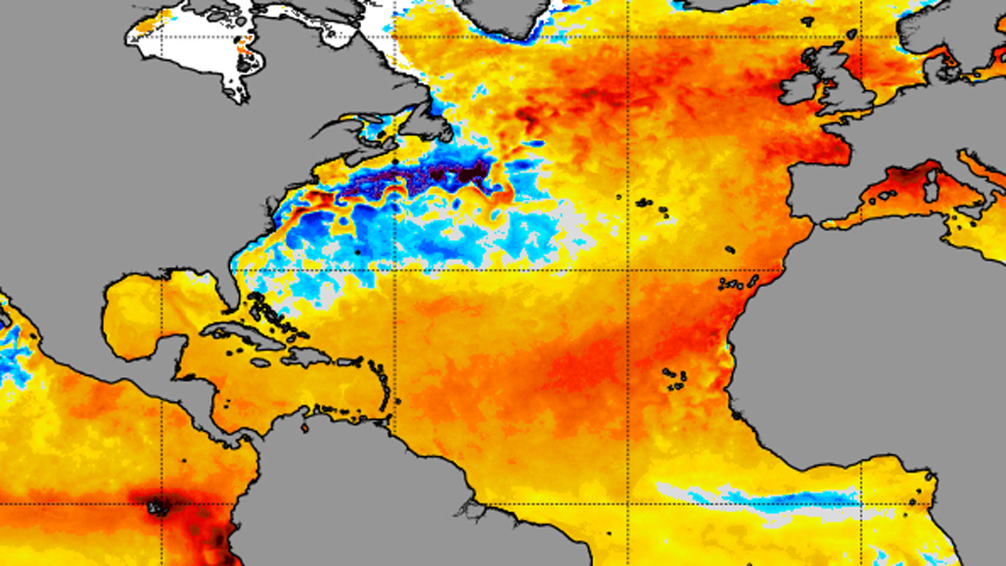 A radar map of the North Atlantic ocean showing large areas of unusually high temperatures in orange and red, with some blue spots near the east coast of North America