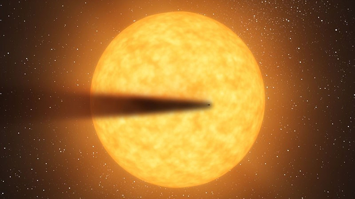 A bright yellow orb of an exoplanet with a dark shadowy streak running almost all the way across it