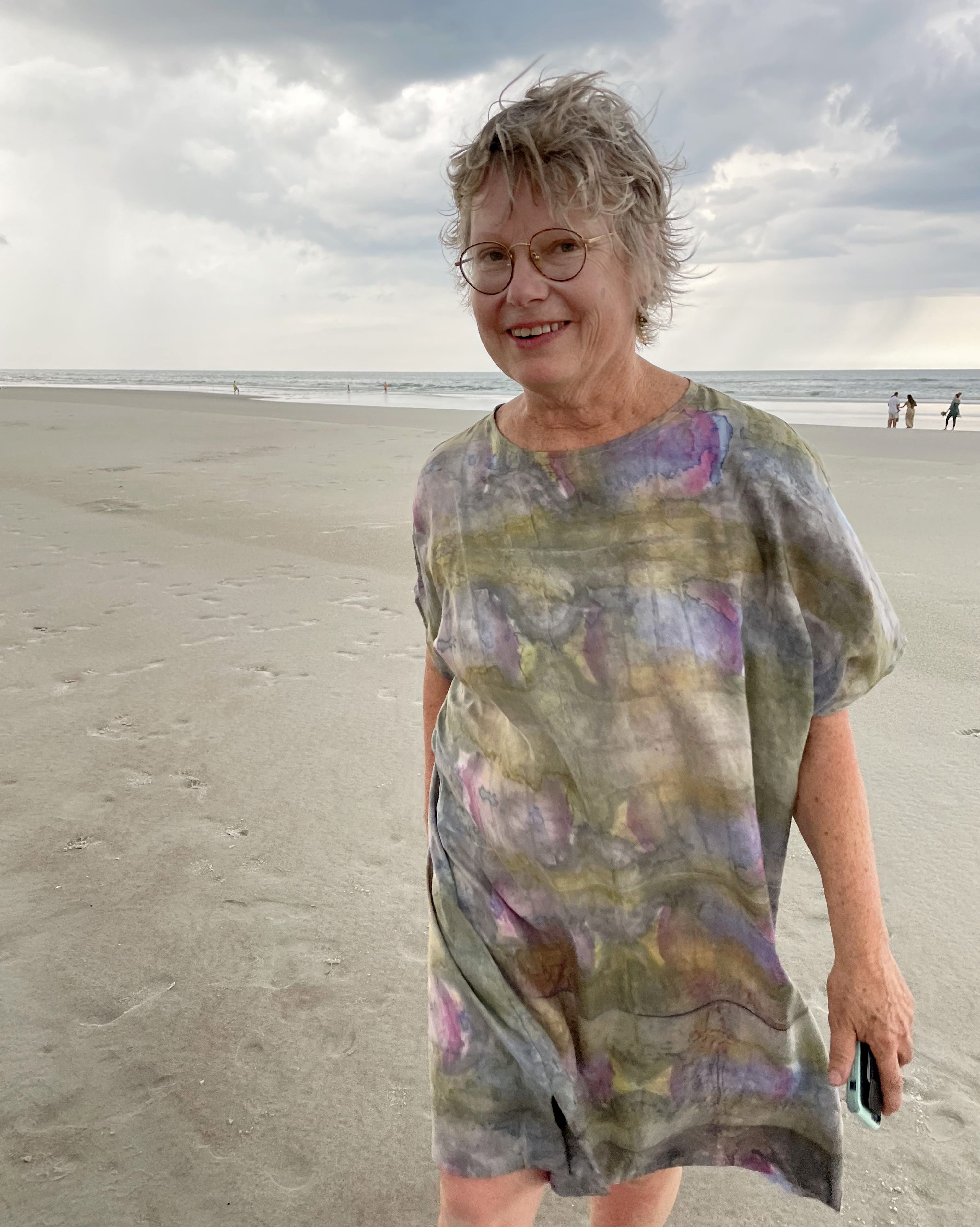 Carrie Shobe Kwok smiles for a photo on a beach.