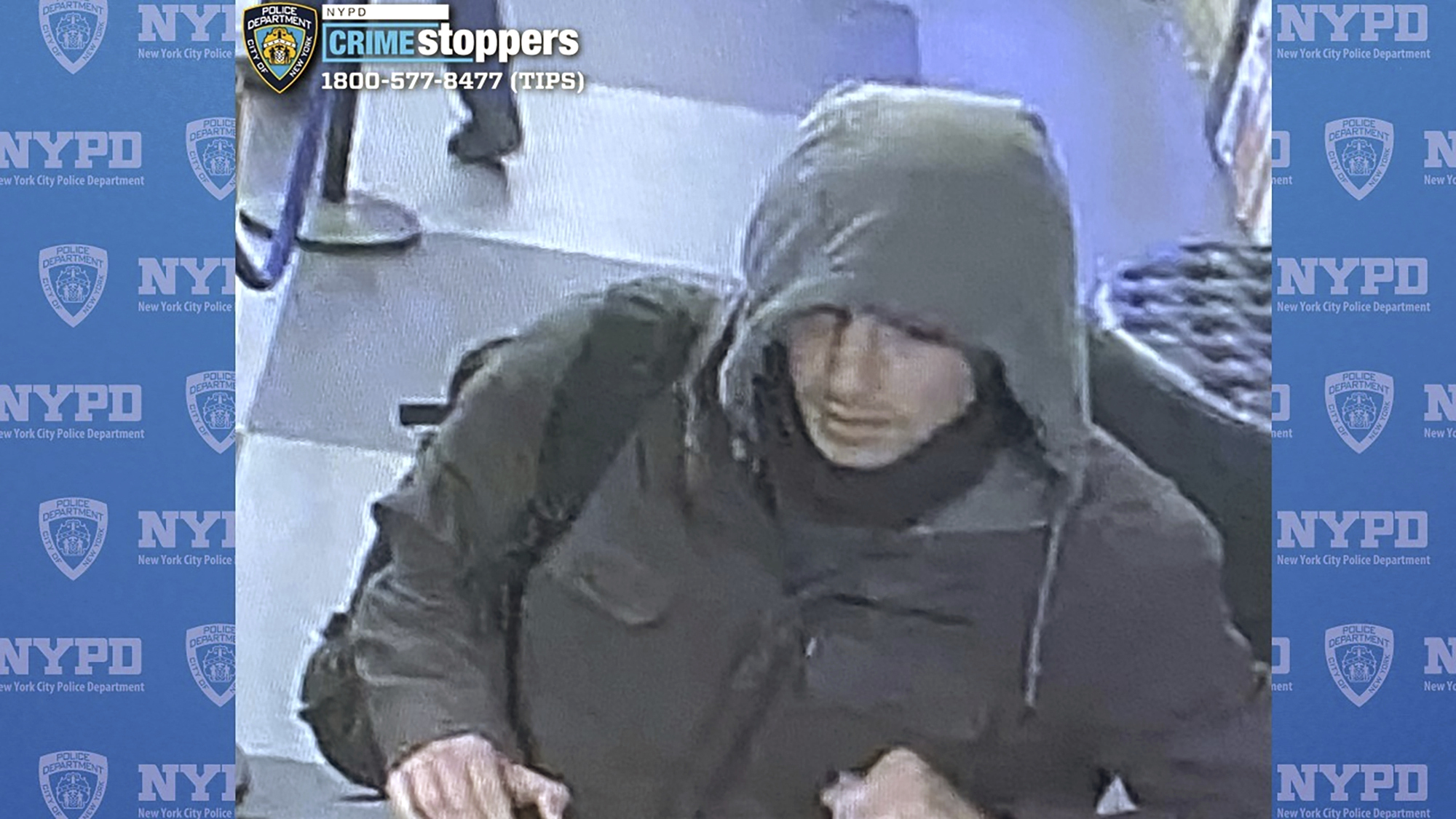 Surveillance image showing a man wearing a hooded jacket. 