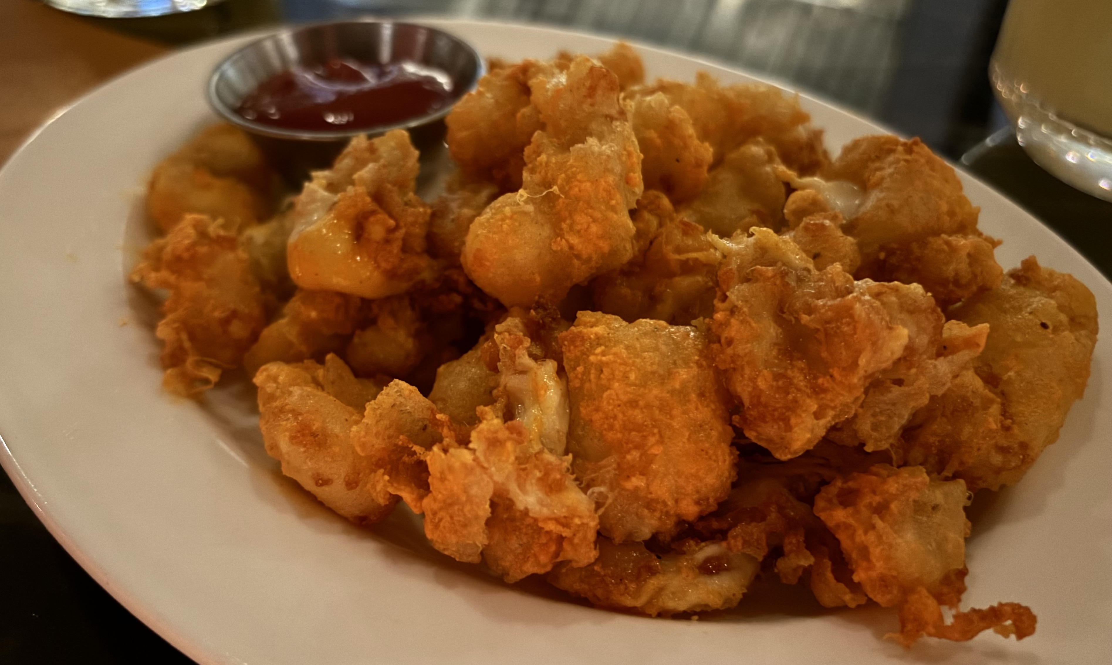 Cheese curds at Dexter's, a sports bar in Minneapolis from chef Daniel del Prado, were served Oct. 17, 2024, dusted with cheddar cheese powder. (Jared Kaufman / Pioneer Press)