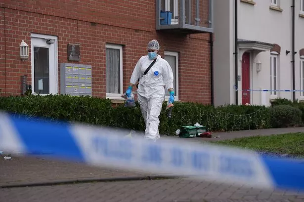 A police cordon and a police forensic officer at the scene near an apartment block on Santa Cruz Avenue in Newton Leys, near Bletchley, Buckinghamshire, where two women, aged 38 and 24, died