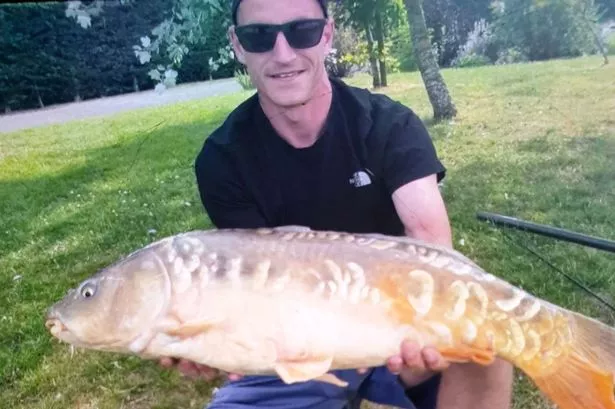 Louis Price holding a fish he has caught