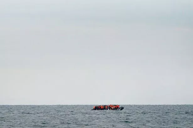 A group of people thought to be migrants crossing the Channel in a small boat travelling from the coast of France and heading in the direction of Dover, Kent, in August 2023 (Gareth Fuller/PA)