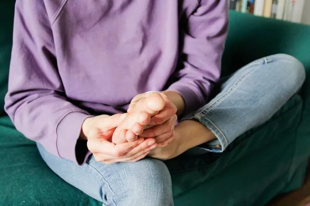 A woman rubbing her feet