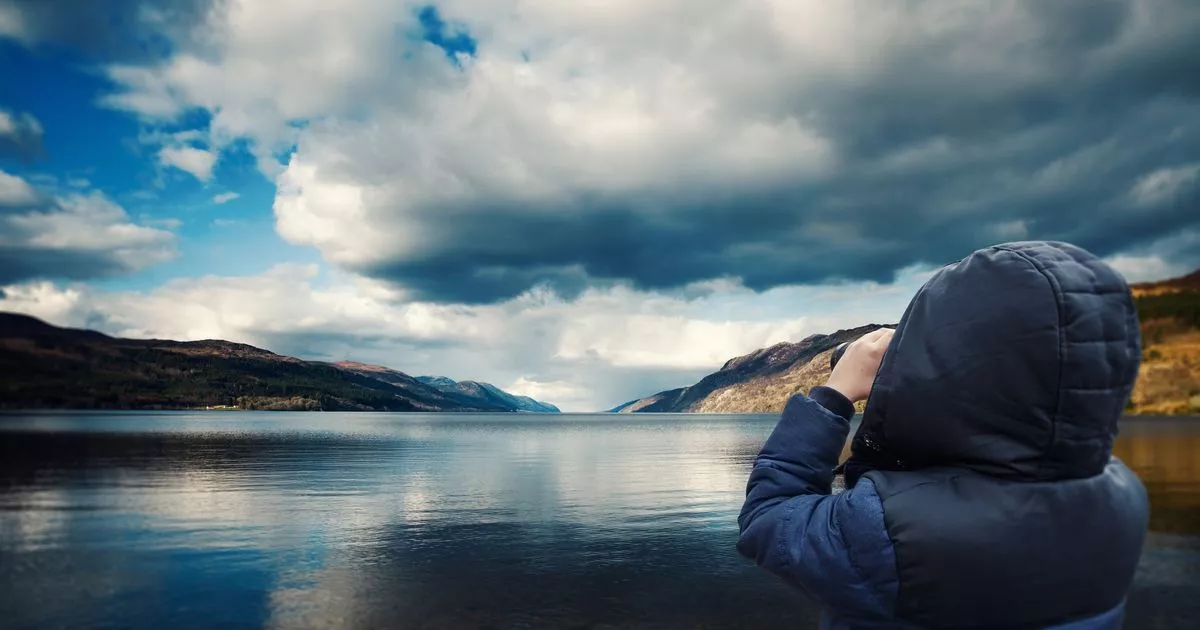 Child in hooded coat searching for Loch Ness monster