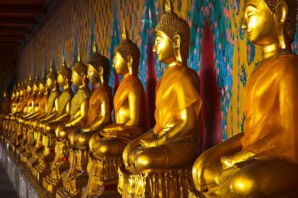 The long line of golden Buddhas in Wat Arun, The Temple of the Dawn. Bangkok, Thailand, Southeast Asia, Asia.