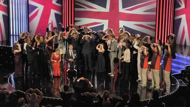 King chares Charles with members of Team GB doing the 'Mobot' at the Daily Mirror Pride of Britain Awards