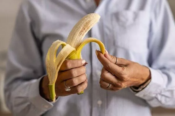 Close up of a person peeling a banana