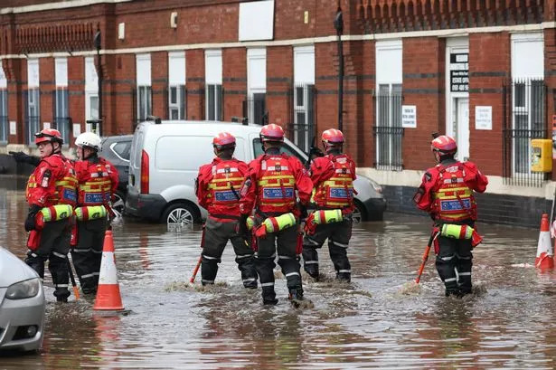 Rescue crews in flooded car park