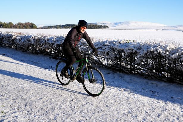 man on snowy bike 