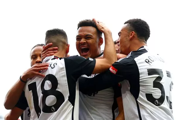 Rodrigo Muniz of Fulham celebrates scoring his team's first goal with teammates Andreas Pereira and Antonee Robinson during the Premier League match between Fulham FC and Crystal Palace at Craven Cottage on April 27, 2024