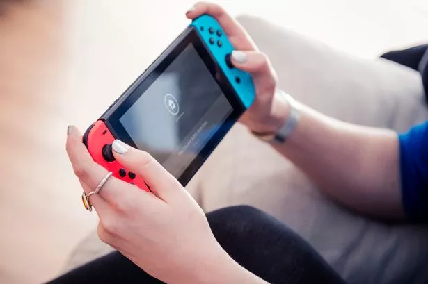 Detail of a young woman playing video games on a Nintendo Switch home console, taken on March 7, 2017. (Photo by James Sheppard/Future via Getty Images)