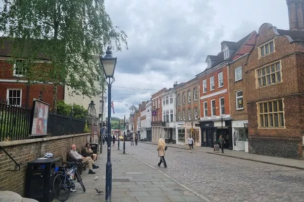 Guildford High Street on a gloomy and cloudy day in Summer.