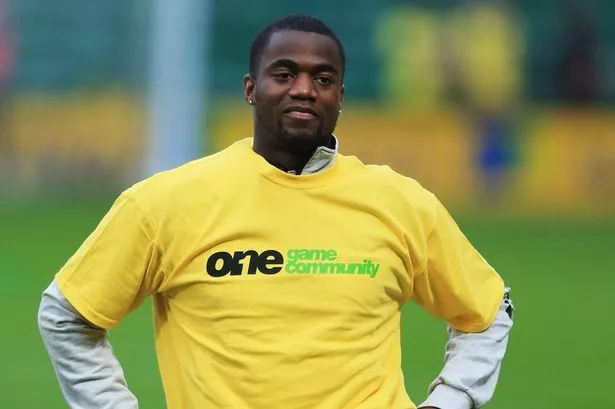 Sebastien Bassong of Norwich City wears Arsenal t-shirt for the the Kick It Out campaign prior to the Barclays Premier League match between Norwich City and Arsenal at Carrow Road on October 20, 2012 in Norwich, England