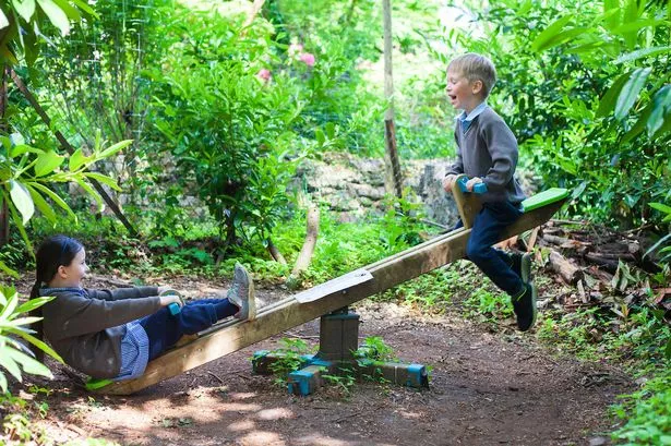 Two kids play on see saw