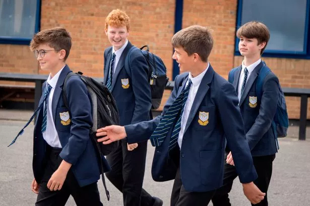 Boys walk past camera