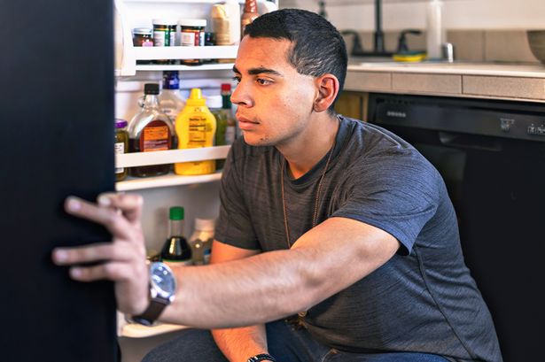 A man opening a fridge