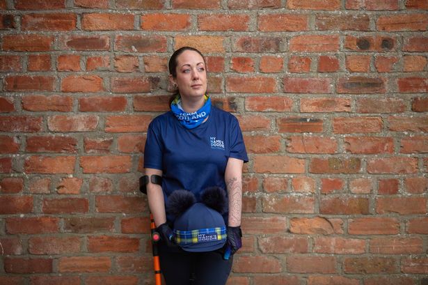 Sheree Gregg leaning against a wall wearing My Name'5 Doddie merchandise